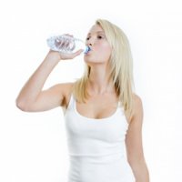 woman drinking water in a bottle