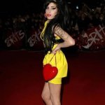 Amy Winehouse at brit awards in a yellow short dress