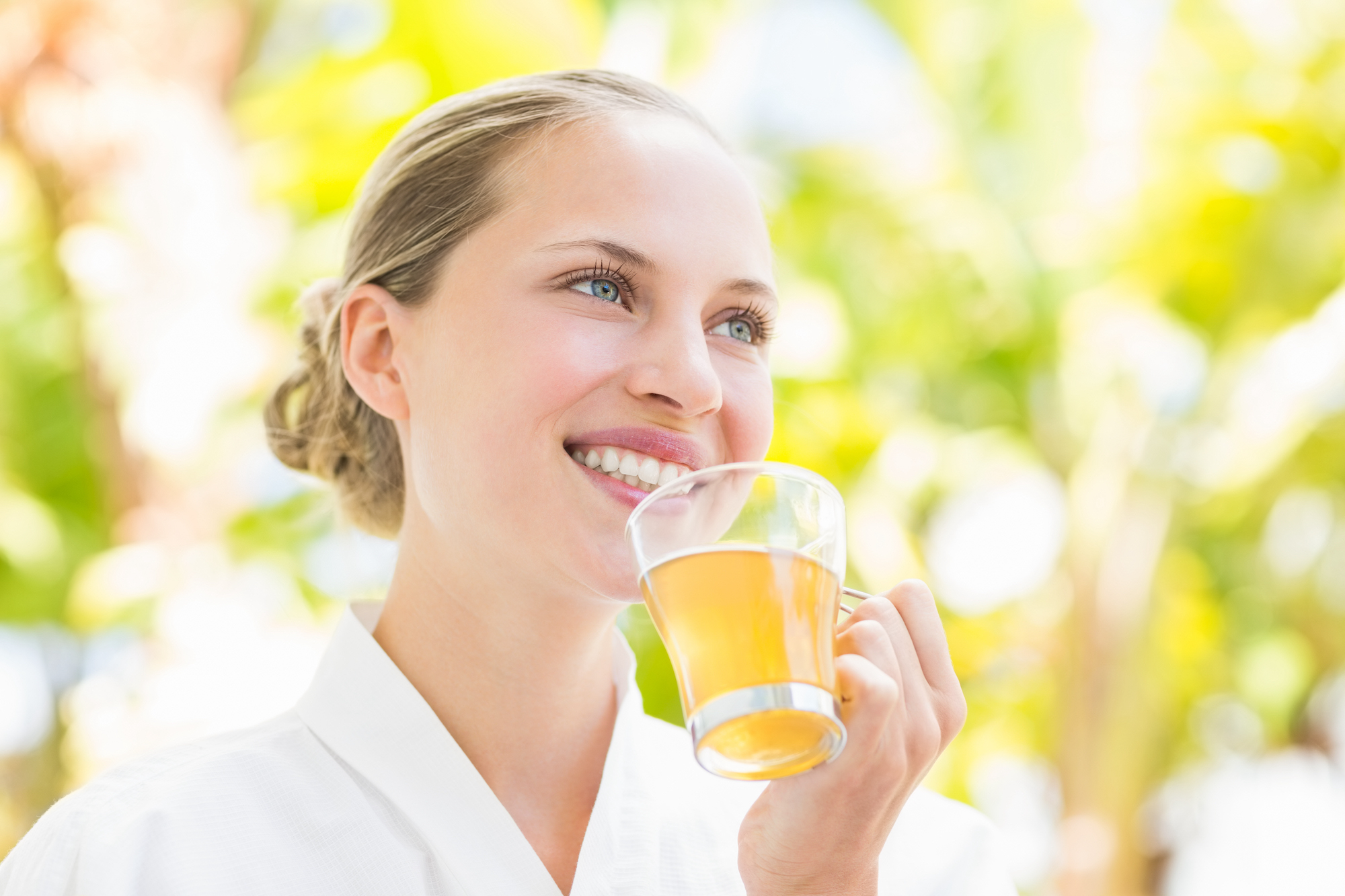 Attractive woman drinking tea in a glass at spa center