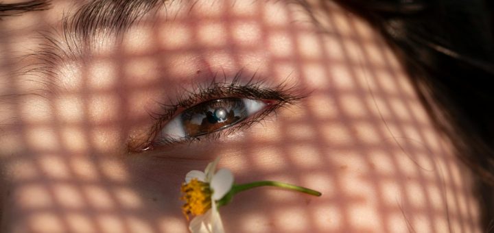 woman with little flower near her eye