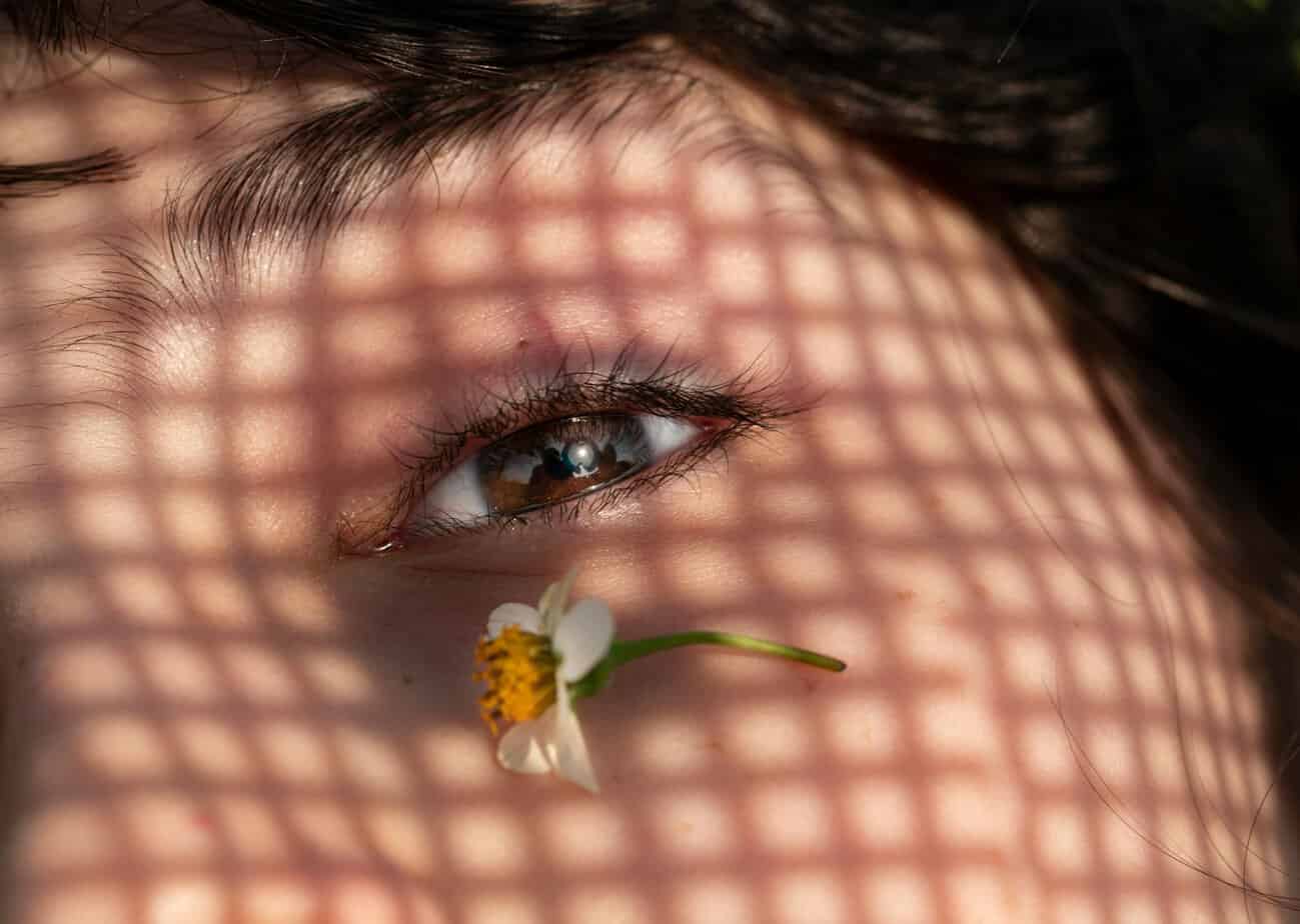 woman with little flower near her eye