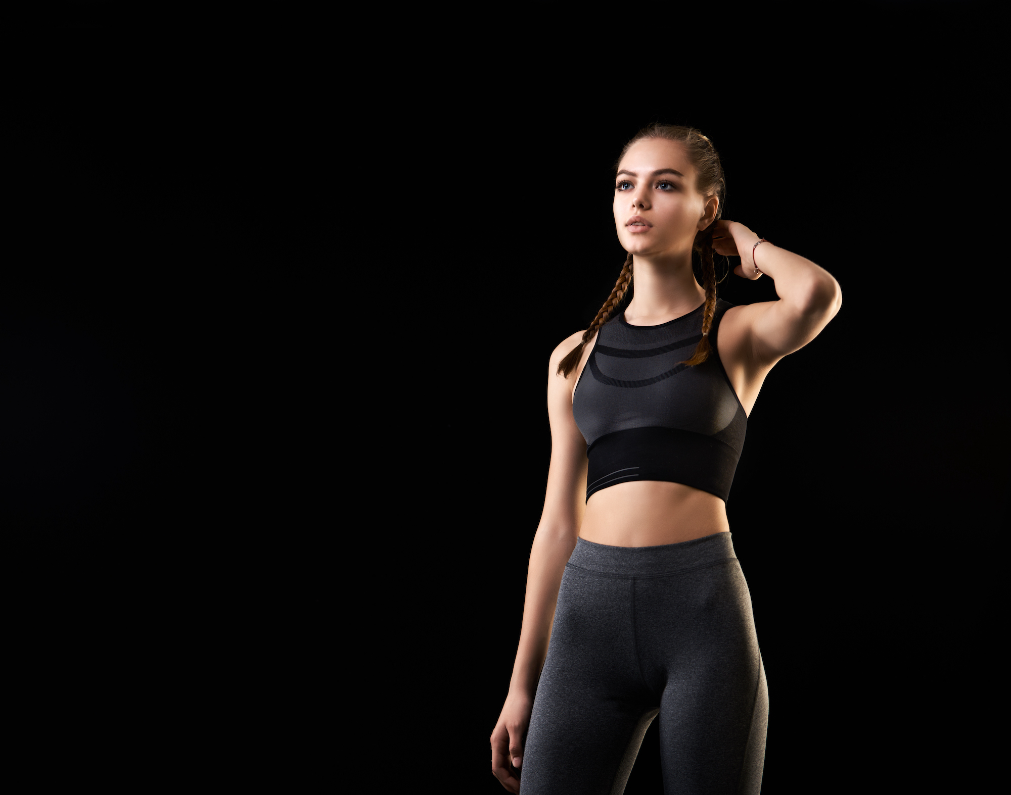 Healthy lifestyle and sport concepts. Woman in fashionable sportswear is doing exercise.