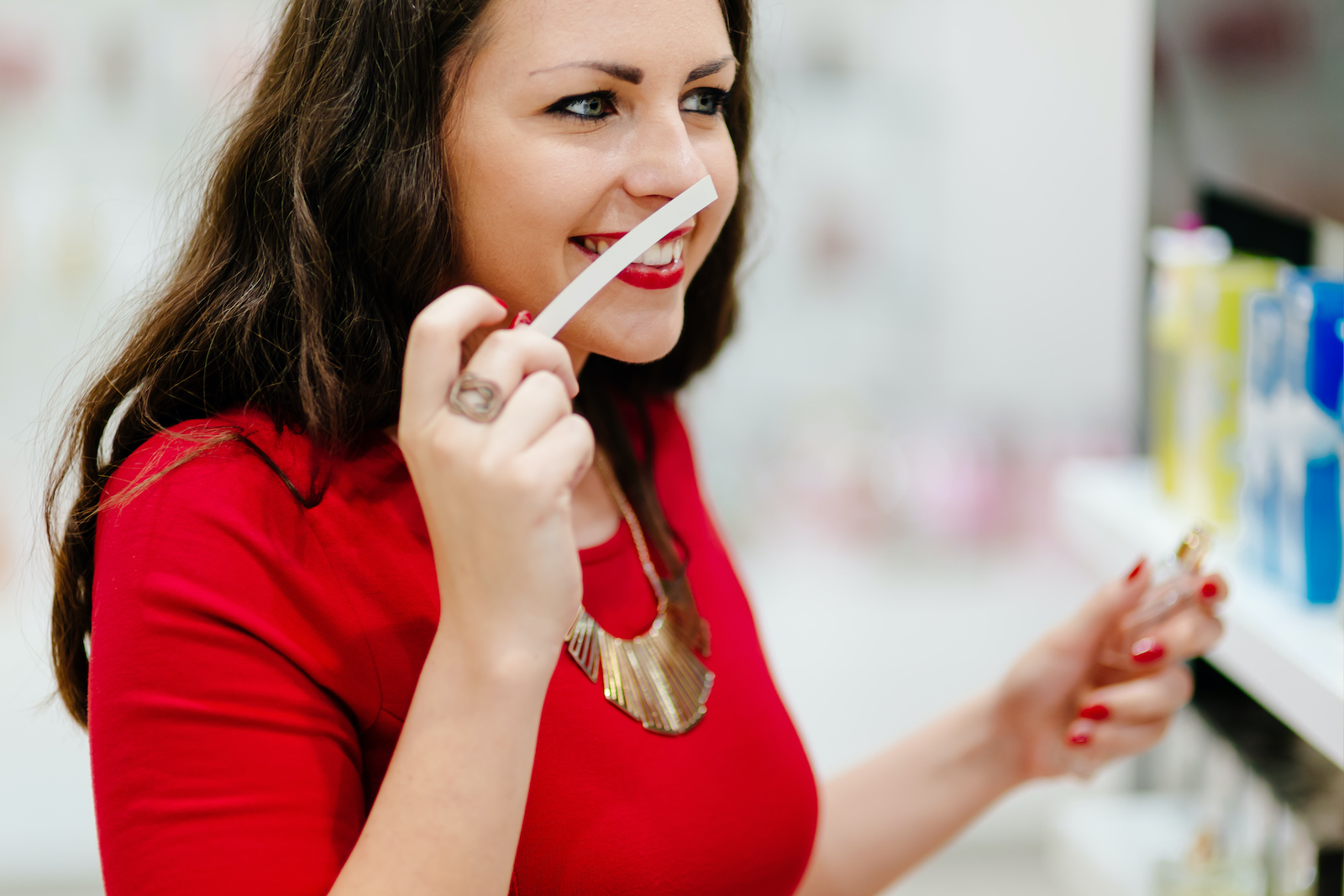 Happy woman testing new fragrances