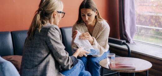 A sad crying woman on a visit to a psychotherapist talks about her problems and traumas.