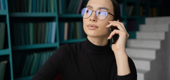 Portrait of a freelancer woman with glasses working in an office, workplace coworking space