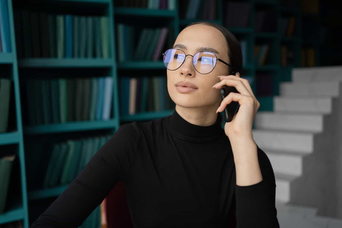 Portrait of a freelancer woman with glasses working in an office, workplace coworking space