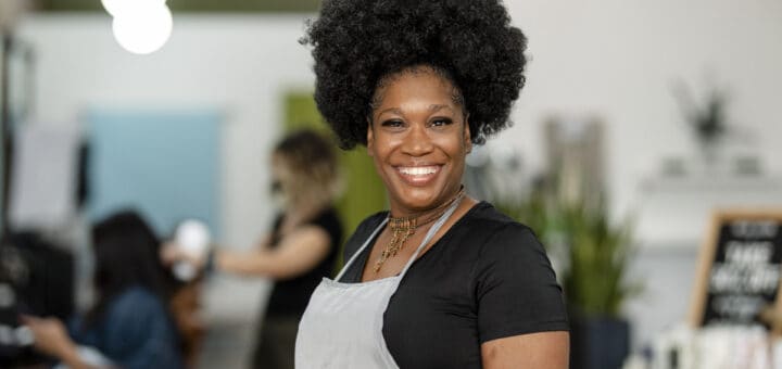 Smiling small beauty salon owner